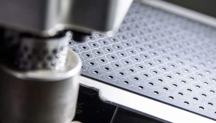 Tiny aerosol seal gaskets cut from a sheet of black high performance material. The gaskets must be highly accurate.