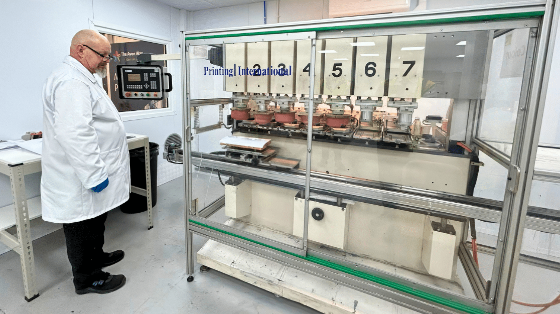 A man checks the new multi colour print machine