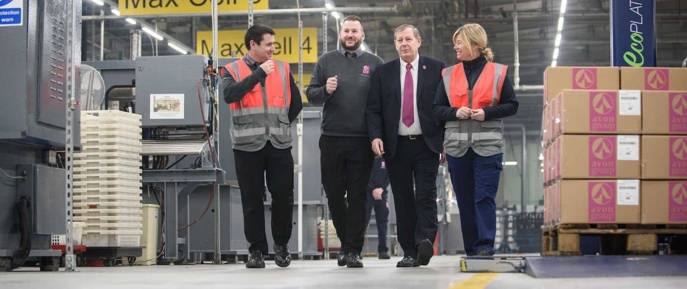 Colleagues walk through the factory at Avon Engineered Rubber