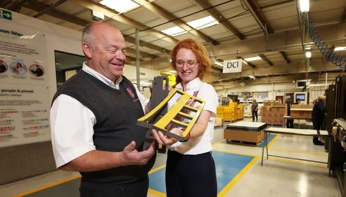 A man and a woman in the Avon TSA factory holding foam gasket components supplied to a car manufacturer.